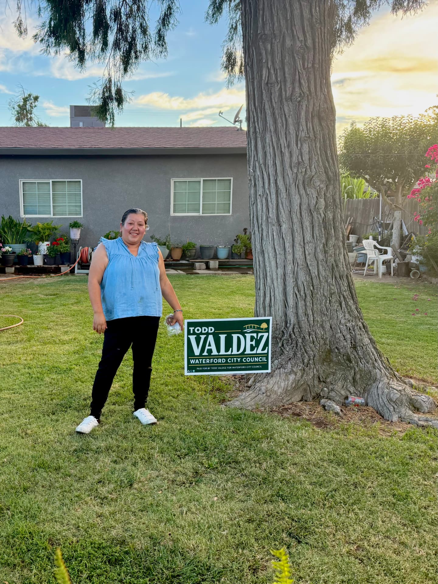 A Waterford resident beside a Todd Valdez yard sign